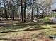 Expansive backyard with lush green lawn and mature trees, complete with a charming wishing well at 5834 Heardsville Rd, Cumming, GA 30028