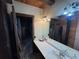 Bathroom featuring wood accents, dual sinks, and rustic lighting fixtures at 5834 Heardsville Rd, Cumming, GA 30028