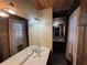 Bathroom featuring wood accents, a large mirror, and rustic lighting fixtures at 5834 Heardsville Rd, Cumming, GA 30028