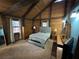 Bedroom with exposed beams, neutral walls, and a comfortable bed with side tables at 5834 Heardsville Rd, Cumming, GA 30028