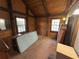 Rustic bedroom with exposed wood beams, neutral carpet, and natural light from two windows at 5834 Heardsville Rd, Cumming, GA 30028
