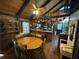 Cozy dining room area showcases rustic charm with wood paneling and a unique collection of hanging baskets at 5834 Heardsville Rd, Cumming, GA 30028