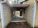 Covered outdoor patio area with weathered wood planks, perfect for relaxation at 5834 Heardsville Rd, Cumming, GA 30028