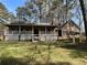 Inviting home exterior featuring a spacious front porch and well-maintained lawn with an ornamental well at 5834 Heardsville Rd, Cumming, GA 30028