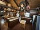 Rustic kitchen boasts wooden cabinets, brick floors, and unique hanging pot rack feature for a quaint, country feel at 5834 Heardsville Rd, Cumming, GA 30028