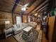 Inviting living room with wood-paneled walls, ceiling fan, and an open layout great for entertaining at 5834 Heardsville Rd, Cumming, GA 30028