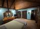 Main bedroom with exposed beams, blue walls, and traditional wood furnishings at 5834 Heardsville Rd, Cumming, GA 30028