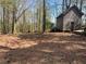 Rustic outbuilding with an aged wood exterior surrounded by pine needle ground covering and mature trees at 5834 Heardsville Rd, Cumming, GA 30028