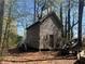Rustic outbuilding with an aged wood exterior and boat, offering a unique storage or workshop space at 5834 Heardsville Rd, Cumming, GA 30028