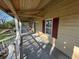 Inviting covered porch with wood railings and ample space for relaxation and enjoying the outdoors at 5834 Heardsville Rd, Cumming, GA 30028