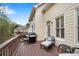 Relax on the deck of this home with chair, gas grill and wooded views at 611 Vinings Estates Se Dr, Smyrna, GA 30126