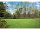 Spacious backyard offering ample green space and a wooden fence at 611 Vinings Estates Se Dr, Smyrna, GA 30126