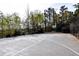 Outdoor basketball court with fencing and lighting for recreational use at 611 Vinings Estates Se Dr, Smyrna, GA 30126