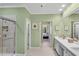 Bright bathroom featuring a walk-in shower, double sink vanity, and an open doorway to an adjacent bedroom at 611 Vinings Estates Se Dr, Smyrna, GA 30126