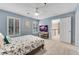 Serene bedroom features blue walls, carpet, a ceiling fan, and white shutters for a comfortable retreat at 611 Vinings Estates Se Dr, Smyrna, GA 30126