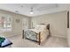 Bedroom with carpet, ceiling fan and natural light, plus white shutters and a wrought iron bedframe at 611 Vinings Estates Se Dr, Smyrna, GA 30126