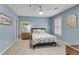 Cozy bedroom with light blue walls, carpet, and white shutters and decor creating a serene atmosphere at 611 Vinings Estates Se Dr, Smyrna, GA 30126