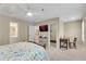 Bright bedroom with a ceiling fan, TV, and desk with a chair at 611 Vinings Estates Se Dr, Smyrna, GA 30126