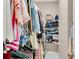 Walk-in closet with ample hanging space, shelving, and an organized display of clothing and accessories at 611 Vinings Estates Se Dr, Smyrna, GA 30126