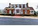 Charming clubhouse exterior with brick facade, columns, and manicured landscaping at 611 Vinings Estates Se Dr, Smyrna, GA 30126