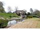 Scenic view of the property with a waterfall feature and lush landscaping, creating a tranquil environment at 611 Vinings Estates Se Dr, Smyrna, GA 30126