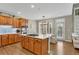 Modern kitchen with stainless steel appliances, center island with cooktop, and a dining area with ample seating at 611 Vinings Estates Se Dr, Smyrna, GA 30126