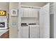 Laundry room featuring washer, dryer, white cabinets, and view of the fireplace in the living room at 611 Vinings Estates Se Dr, Smyrna, GA 30126