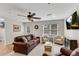 Spacious living room featuring a leather sofa, chairs, and a window at 611 Vinings Estates Se Dr, Smyrna, GA 30126