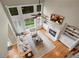 Sunlit two-story living room with a fireplace, built-in shelving, hardwood floors and wooded views at 611 Vinings Estates Se Dr, Smyrna, GA 30126