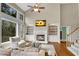 Bright living room with fireplace and built-ins, large windows offer natural light, hardwood floors and comfortable seating at 611 Vinings Estates Se Dr, Smyrna, GA 30126