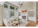 Inviting living room with fireplace, built-in shelving, and large windows offering natural light at 611 Vinings Estates Se Dr, Smyrna, GA 30126