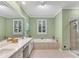 Luxurious bathroom with double vanity, soaking tub, glass shower, and tile flooring at 611 Vinings Estates Se Dr, Smyrna, GA 30126
