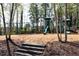 Community playground with swings and slides nestled among mature trees at 611 Vinings Estates Se Dr, Smyrna, GA 30126