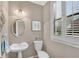 Elegant powder room with stylish fixtures and a window letting in natural light at 611 Vinings Estates Se Dr, Smyrna, GA 30126
