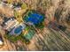 Aerial view featuring manicured grounds with tennis court, basketball court, pool, and stately home at 9044 Riverbend Manor, Alpharetta, GA 30022