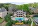 Aerial view of community building with a pool, tennis court, and beautiful landscaping at 9044 Riverbend Manor, Alpharetta, GA 30022
