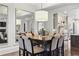 Elegant dining room featuring a square table and decorative mirror enhancing the room's sense of space at 9044 Riverbend Manor, Alpharetta, GA 30022