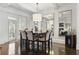 Elegant dining room with stylish chairs, and a modern pendant light fixture at 9044 Riverbend Manor, Alpharetta, GA 30022