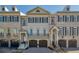 Charming brick townhome with symmetrical design, multiple windows, and integrated garages at 9044 Riverbend Manor, Alpharetta, GA 30022