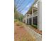 Side view of an elegant brick house featuring a beautiful brick pathway and manicured landscaping at 9044 Riverbend Manor, Alpharetta, GA 30022
