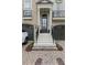 Elegant front entrance with a black door, white pillars, and a brick-paved driveway at 9044 Riverbend Manor, Alpharetta, GA 30022