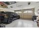 Clean and organized garage with epoxy flooring, ample storage, and a black SUV at 9044 Riverbend Manor, Alpharetta, GA 30022