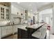 Spacious kitchen with an island, granite countertops, and a mosaic tile backsplash at 9044 Riverbend Manor, Alpharetta, GA 30022