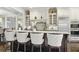 Gourmet kitchen featuring an island with seating, stainless steel appliances, and custom cabinetry at 9044 Riverbend Manor, Alpharetta, GA 30022