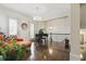Bright living room with hardwood floors, a black piano, an orange sofa, and staircase views at 9044 Riverbend Manor, Alpharetta, GA 30022