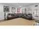 Spacious living room with a large seating area, projector, and natural lighting at 9044 Riverbend Manor, Alpharetta, GA 30022
