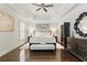 Elegant main bedroom features a tray ceiling, dark hardwood floors, and neutral decor at 9044 Riverbend Manor, Alpharetta, GA 30022