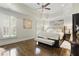 Spacious main bedroom with tray ceiling, plantation shutters, and a luxurious upholstered bed at 9044 Riverbend Manor, Alpharetta, GA 30022