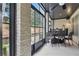 Charming patio with brick walls, an outdoor seating area, and natural light at 9044 Riverbend Manor, Alpharetta, GA 30022