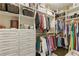 Spacious walk-in closet with custom shelving, drawers, and ample storage space for clothing at 9044 Riverbend Manor, Alpharetta, GA 30022